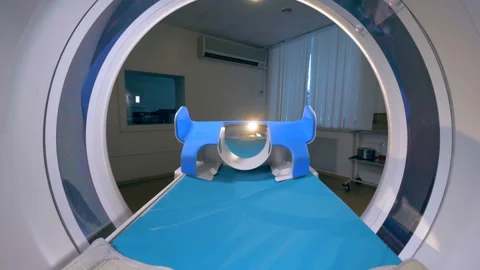 An empty patients cot moves inside a CT scanner. 스톡 동영상 86390515