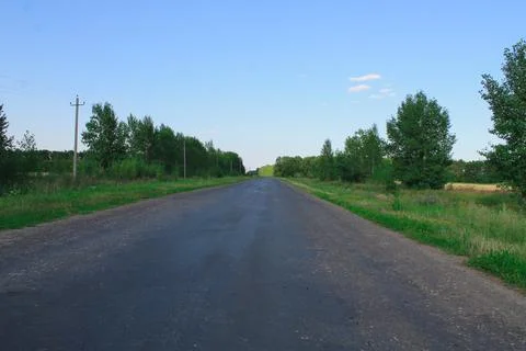 Empty paved road in the forest Stock Photos