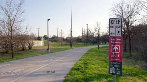 Empty Paved Walking Trail with a Bike and Pedestrian Sign Near Baseball Fields Stock Footage 301490346