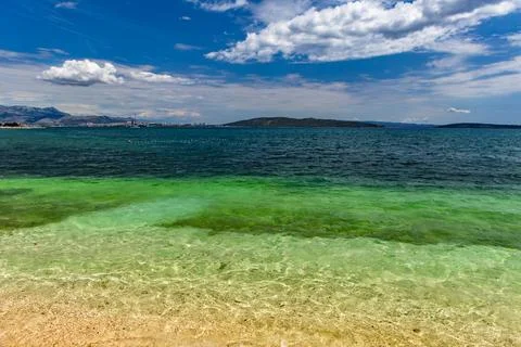 Empty Pebble Beach and Crystal Clear Adriatic Sea Near Kastela Croatia Photos