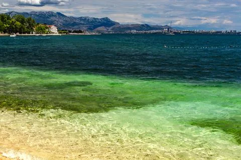 Empty Pebble Beach and Crystal Clear Adriatic Sea Near Kastela Croatia Photos