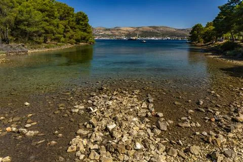 Empty pebble beaches, walking path along the island of Ciovo to Pendi Lagoo.. Stock Photos