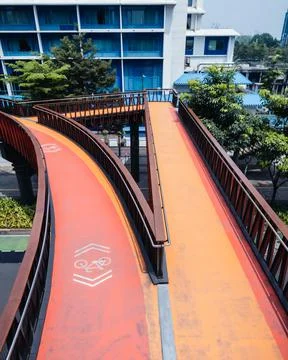 Empty pedestrian bridge during the day with a view of tall buildings Stock Photos