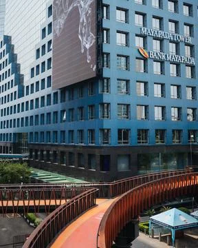 Empty pedestrian bridge during the day with a view of tall buildings Stock Photos