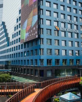 Empty pedestrian bridge during the day with a view of tall buildings Stock Photos