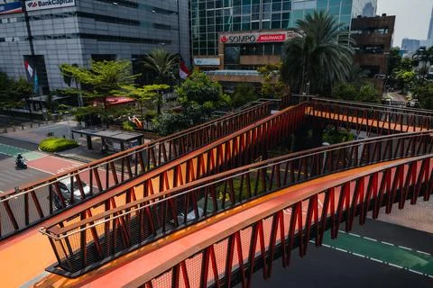 Empty pedestrian bridge during the day with a view of tall buildings Stock Photos