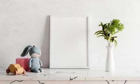 Empty photo frame mockup on white marble table with rabbit doll houseplant .. Illustrazione stock