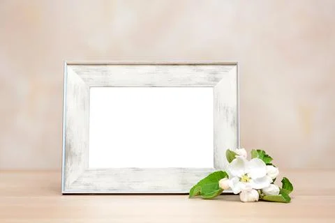 Empty photo frame on table with apple blossom Stock Photos