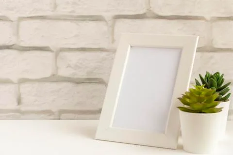 An empty photo frame on a table or shelf with a copy of the space Stock-Fotos