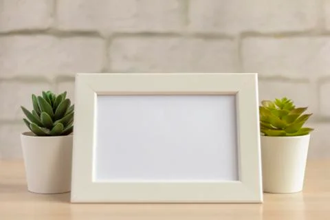 An empty photo frame on a table or shelf with a copy of the space Stock Photos