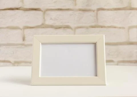 An empty photo frame on a table or shelf with a copy of the space Stock Photos