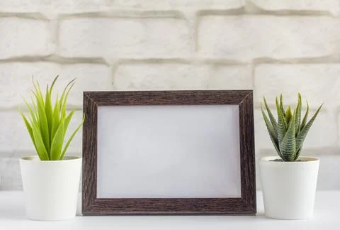 An empty photo frame on a table or shelf with a copy of the space Stock Photos