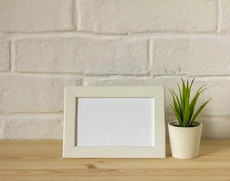 An empty photo frame on a table or shelf with a copy of the space. Stock Photos