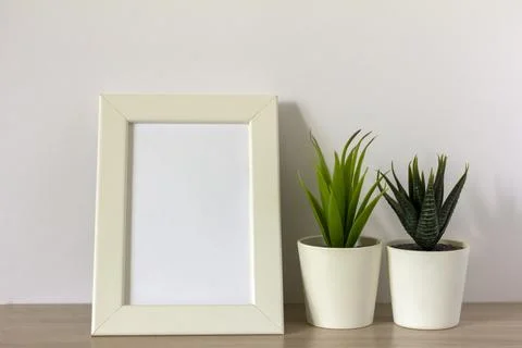 An empty photo frame on a table or shelf with a copy of the space. Stock-Fotos