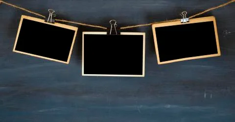 Empty photo frames hanging on dark grungy background, space for your pictures Stock Photos