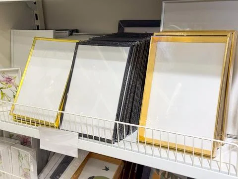 Empty photo frames on a store shelf. Home decor, interior design, and lifesty Stock Photos