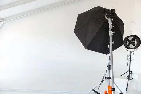 Empty photo studio with lighting equipment. Photographer workplace interior with Stock Photos