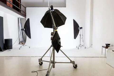 Empty photo studio with lighting equipment. Photographer workplace interior with Stock Photos
