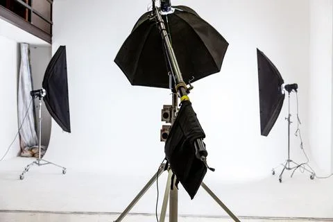 Empty photo studio with lighting equipment. Photographer workplace interior with Stock Photos