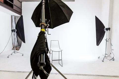 Empty photo studio with lighting equipment. Photographer workplace interior with Stock Photos
