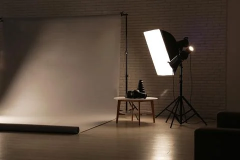 Empty photo studio with white backdrop, professional lighting equipment, and  Stock Photos