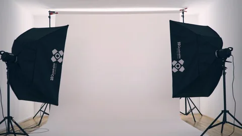 Empty photographic studio with lights and white background, 4K. Stock Footage 128996568