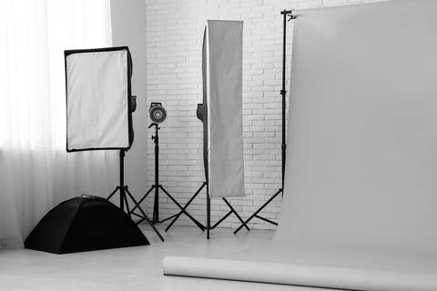 Empty photography studio with lighting equipment and backdrop 库存照片