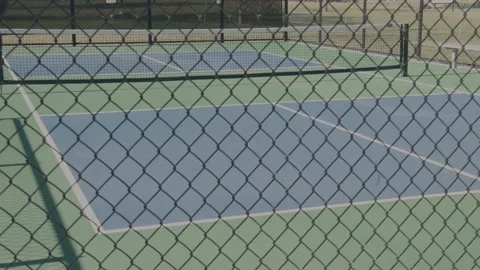 Empty Pickleball Courts Behind Chain Link Fence With Slow Left to Right Pan Video stock 337410271