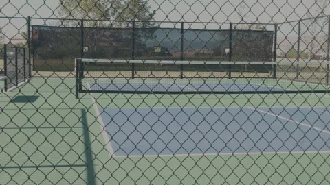 Empty Pickleball Courts Viewed Through Chain Link Fence Stock Footage 337410292