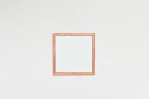 Empty picture frame with blank space for photo or art on a white interior wal Stock Photos