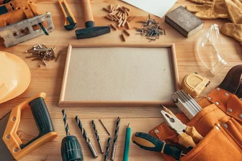 Empty picture frame as copy space on carpentry woodwork desk Stock Photos