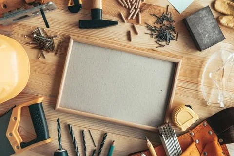 Empty picture frame as copy space on carpentry woodwork desk Stock Photos