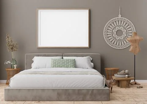 Empty picture frame on grey wall in modern bedroom. Mock up interior in boho  Stock Photos