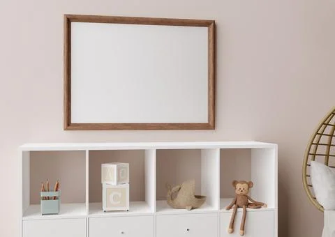Empty picture frame on light brown wall in modern child room. Mock up interio Stock Photos