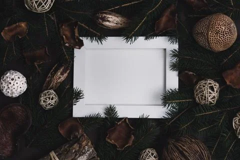 Empty picture frame with pine tree and natural christmas decoration on dark.. Stock-Fotos
