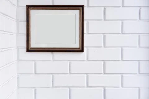 Empty picture frame on a white brick wall. Stock Photos