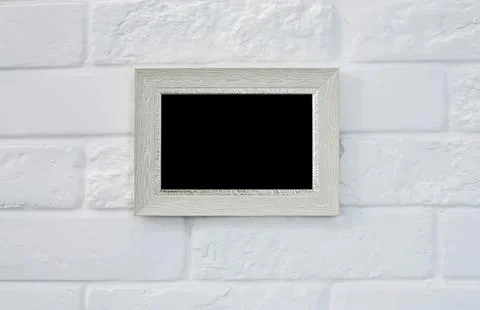 Empty picture frame on white brick wall background Stock Photos
