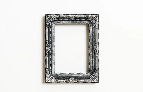 Empty picture frame on white wall background Stock Photos