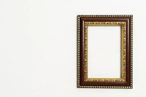 Empty picture frame on white wall background Stock Photos