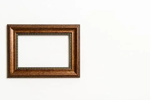 Empty picture frame on white wall background Stock Photos