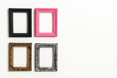 Empty picture frame on white wall background Stock Photos