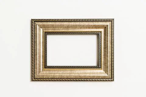 Empty picture frame on white wall background Stock Photos