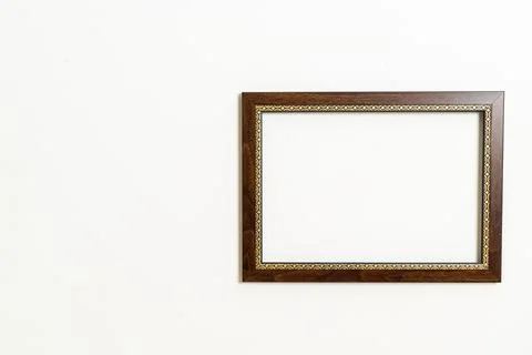 Empty picture frame on white wall background Stock Photos