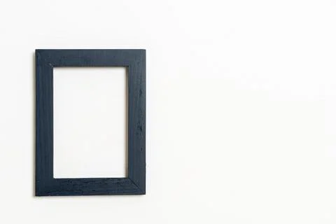 Empty picture frame on white wall background Stock Photos