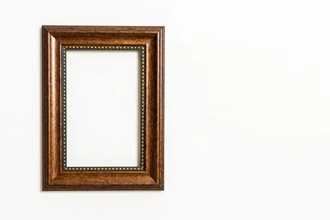 Empty picture frame on white wall background Stock Photos