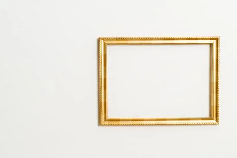 Empty picture frame on white wall background Stock Photos
