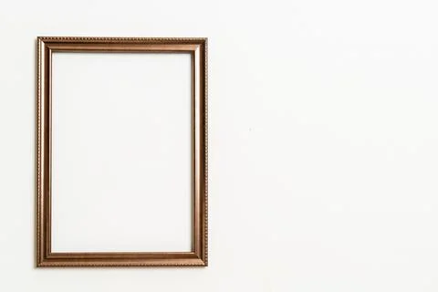Empty picture frame on white wall background Stock Photos