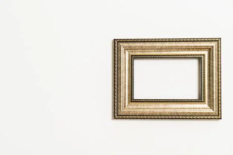 Empty picture frame on white wall background Stock Photos