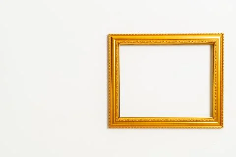 Empty picture frame on white wall background Stock Photos