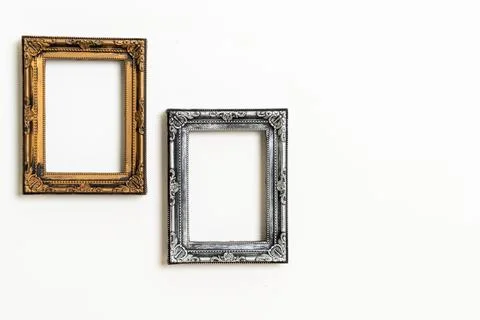 Empty picture frame on white wall background Stock Photos